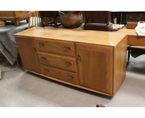 Ercol Windsor Blonde Elm Sideboard, model 455, fitted with an arrangement of three central drawers flanked by a cupboard to e