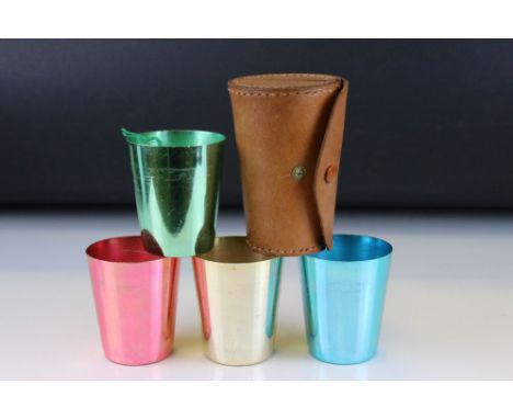 Harlequin Set of Four Lacquered Stacking Stirrup Cups contained in a Cylindrical Leather Case, 11cms high 