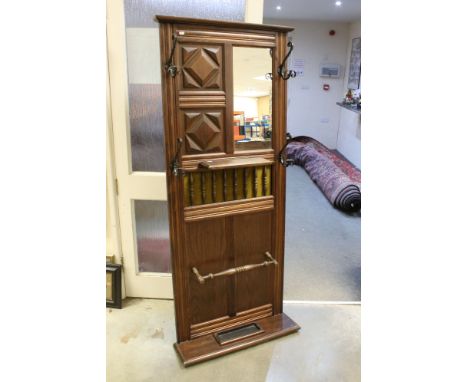 20th century Wall mounted Oak Hallstand with moulded decoration containing a mirror, four wrought iron coat hooks, shelf and 