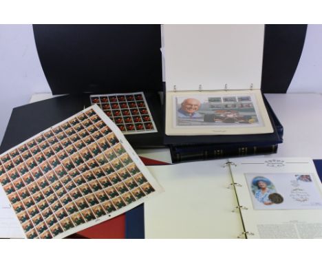 A collection of first day covers, coin covers and stamps contained within albums. 