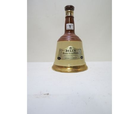 A Bells porcelain Scotch Whisky bottle, sealed and with contents
