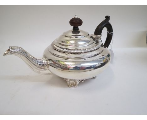 A Regency silver teapot by Robert Hennell, London 1824, of circular form standing on Shell scrolled feet, 6 high, 588 grams