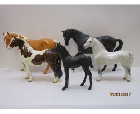 Four Beswick model horses to include a mat black glazed example and a similar foal, 5 6/8 h - 6 3/4 h