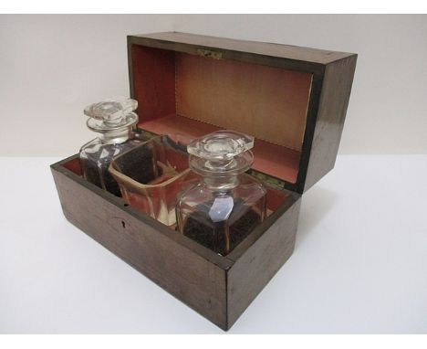 A late 19th century brass inlaid rosewood tea caddy having a hinged, domed top enclosing a pair of clear glass decanters with