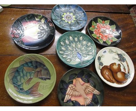 Seven Moorcroft limited edition plates dated between 1989 and 200, signed W M for Walter Moorcroft, to the underside of each 