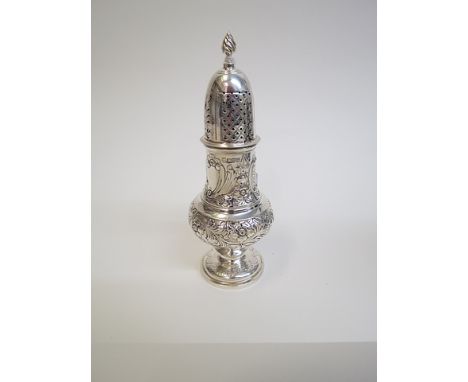 An Edwardian silver sugar castor by George Nathan & Ridley Hayes, Chester 1902, decorated a with flamed finial, floral and sc