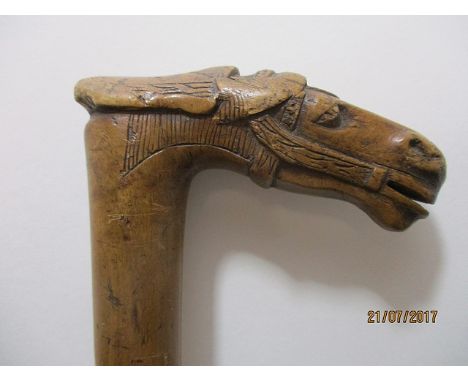 A late 19th century Greek carved fruit wood walking stick, the handle fashioned as a horse's head and inscribed Kepkypa, 35 1