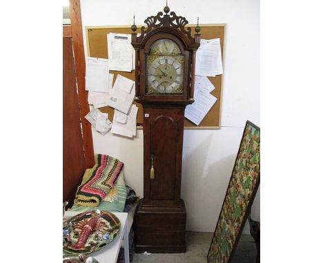 A George III oak longcase clock, the hood having a fretwork pediment over an arched door, box base on a plinth, the eight day