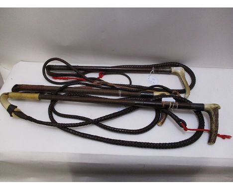 Two late Victorian hunting whips, one by Swain & Co, the other by Briggs, and a mid 20th century example, each with a horn ha