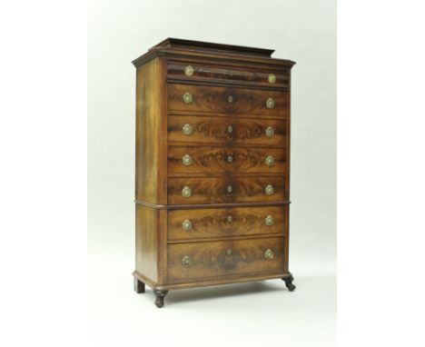 A late 19th Century mahogany chest in the Biedermeier taste, the caddy top over seven drawers with brass wreath ring handles,