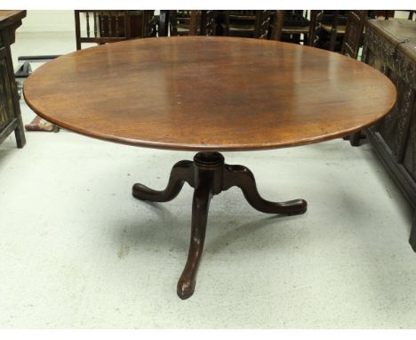 A modern oak breakfast table in the 18th Century manner, the circular top on a turned and ringed centre pedestal to cabriole 