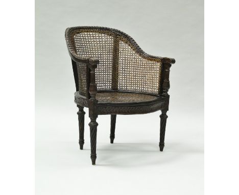 A 19th Century carved oak framed bérgère chair, the yoke back with heavy beaded decoration on acanthus carved and lotus leaf 