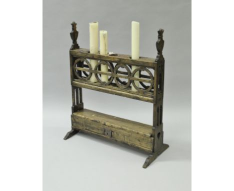 A walnut four section candle holder in the 17th Century Spanish manner, the plain holders on Gothic style urn capped fretwork