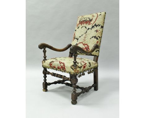 An 18th Century Flemish walnut flamed hall chair, the tapestry upholstered back and seat of floral design flanked by foliate 