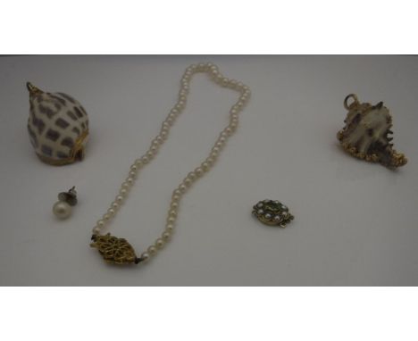 A pearl necklace with 9ct gold clasp, a further 9ct gold stone and peal set clasp and two yellow metal mounted shell pendants