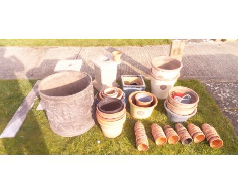 A collection of various glazed and/or terracotta plant pots, a simulated lead planter bearing date 1757 and two concrete urn 