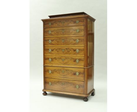 A late 19th Century French mahogany chest in the Biedermeier taste, the caddy top over seven drawers with brass wreath handle