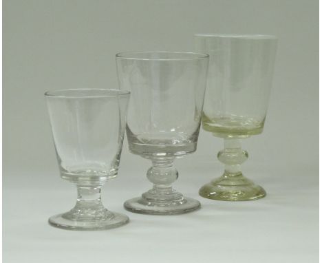 An early 19th Century glass rummer of tapering bucket form with white enamel rim, raised on a knop stem to stepped circular f
