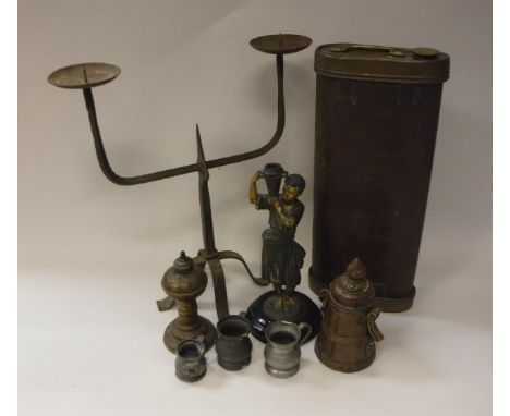 An iron twin pricket candlestick, a pair of spelter figures of blackamoor water carriers, a Middle Eastern brass oil lamp, a 