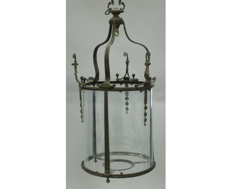 An early 20th Century brass framed cylindrical hanging lantern in the Georgian manner with three plain glass panels, 44 cm di