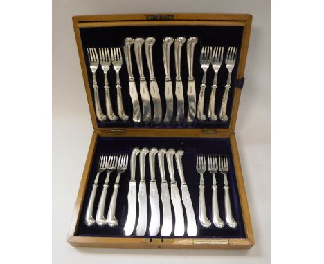 An oak cased set of twelve George V silver pistol grip handled knives and forks (by Martin Hall &amp; Co. Limited, Sheffield 