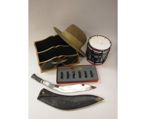 A collection of various Gurkha ephemera including ice bucket, stationery holder, desk tidy, two coasters, kukri, leather scab