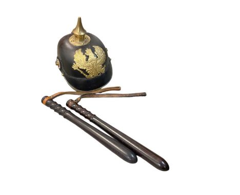 Replica First World War Imperial German Picklehaube, together with two truncheons stamped with broad arrow marks and a Second