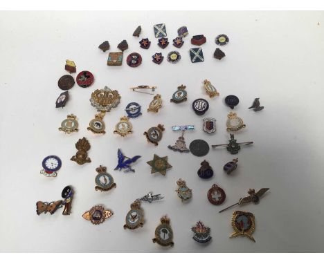 Selection of enamel badges including Daily Express Rupert, Butlins, Golden Shred Golfer, RAF, Army etc.