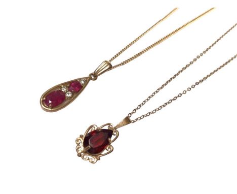 Ruby and diamond pendant necklace, the pear shape drop with two oval mixed cut rubies and three brilliant cut diamonds in 9ct