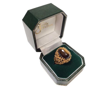 1970s tiger's eye cabochon ring in a 9ct gold textured naturalistic claw setting, size O½Weight 8.8 grams