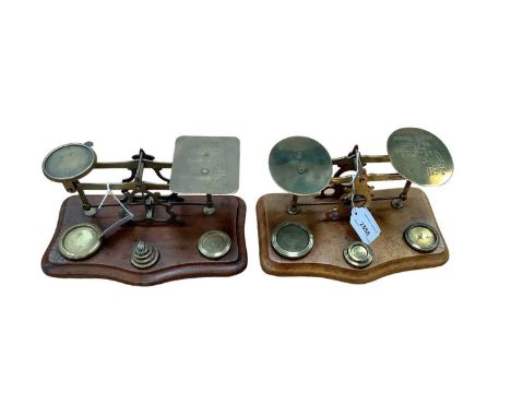 Two pairs Victorian brass postal scales with weights on shaped walnut bases (2)