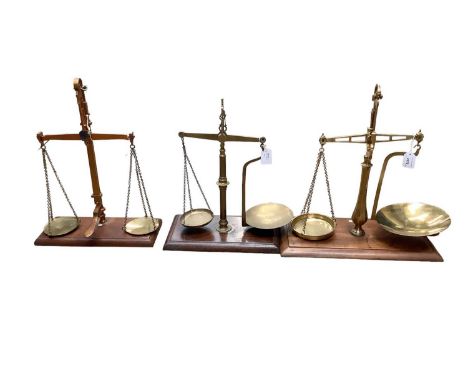 Three sets of Victorian brass and mahogany balance scales, including one by Parnell &amp; Sons Bristol, one stamped 'Barnsley