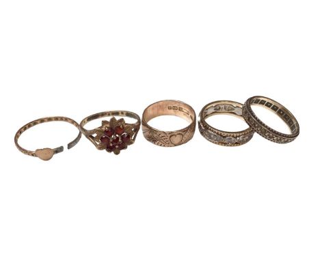 Five 9ct gold rings including a garnet flower head cluster, two eternity style rings, engraved wedding band and one other bro
