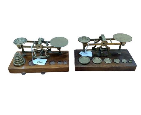 Two pairs Victorian brass postal scales by S.Mordan &amp; Co, London on walnut bases complete with brass graduated weights (2