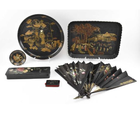 A collection of vintage 20th century Chinoiserie black lacquerware. The lot comprising two gilt Chinese trays, one circular &