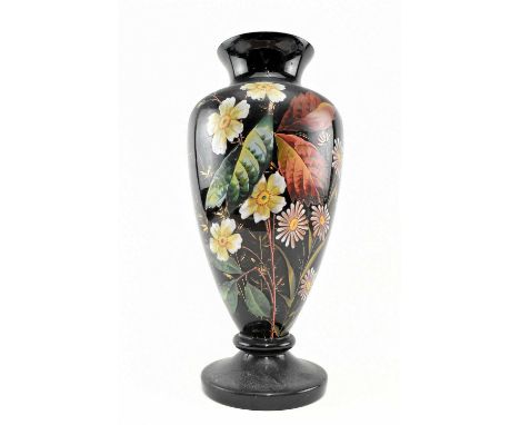 A late 19th century Victorian black ceramic footed vase featuring central hand painted floral display. The vase of baluster f