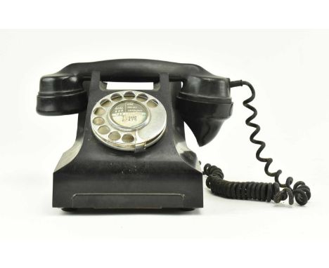 A vintage early to mid 20th century GPO 332L Bakelite rotary telephone. The phone marked to dial for Torquay.