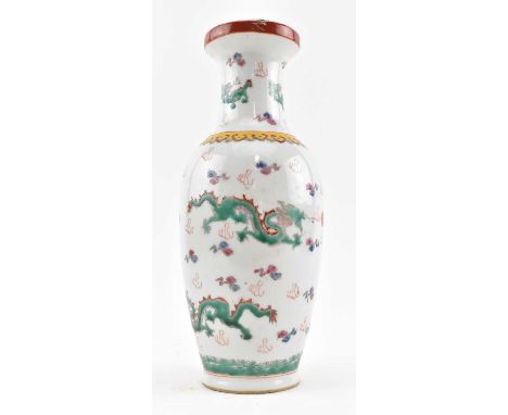 A 20th century famille rose ceramic vase. The baluster shaped vase decorated with two green enamelled dragons amidst clouds a