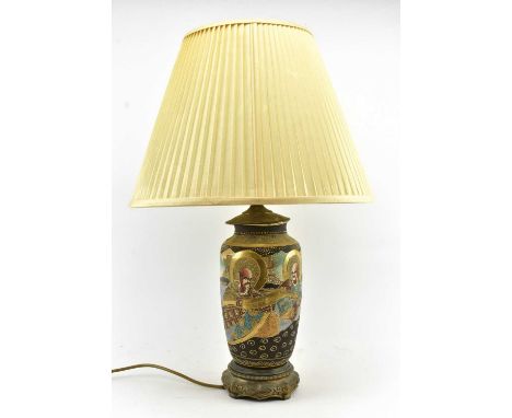 A 20th century Japanese Satsuma ware vase having been converted to a lamp. The bedside lamp light with shade over vase featur