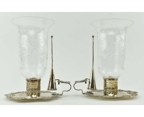 A pair of vintage silver plated candle holders with glass shades. Each candle holder having a silver plated waved edge base w