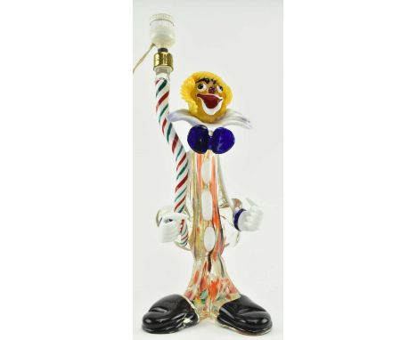 A retro 20th century Murano glass figural lamp in the form of a clown. The clown with two thumbs up standing by a green and r