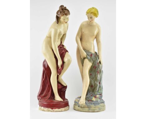 A pair of vintage mid 20th century plaster Neoclassical figurines of nude ladues. Each painted, featuring robe over legs &amp