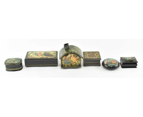 A collection of six vintage Russian lacquered souvenir trinket boxes. The lacquerware comprising a box in the shape of a hous