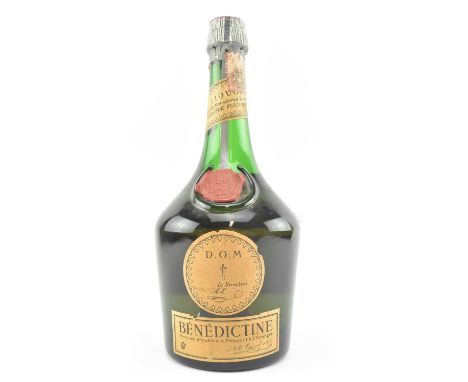 A vintage bottle of D.O.M Benedictine liquor, Product of France. Seal intact. Some damage to paper labels.