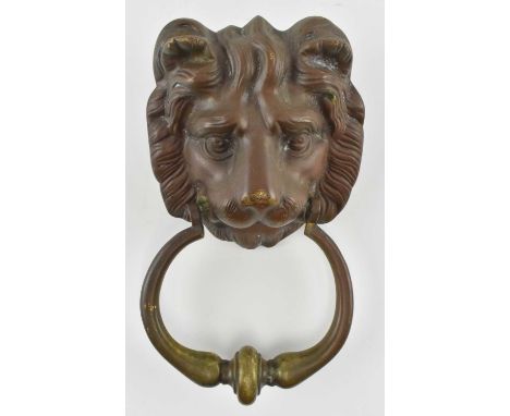 A 19th century Victorian brass door knocker handle in the form of a lion. The lion with ring knock in its maw. Screw mount fi