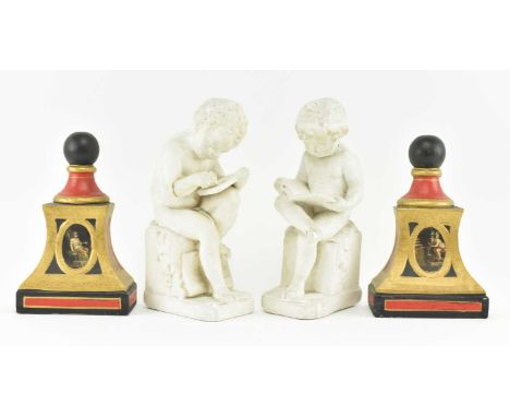 A pair of 20th century heavy plaster bookends in the form of cherubs, along with two plaster book ends / doorstops with centr