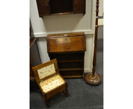 An early-20th century oak writing bureau, fall front enclosing pigeon holes above four shelves; an early-20th century light o