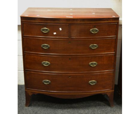 An early-Victorian mahogany bow fronted chest of drawers, two short above three long cockbeaded drawers, satin wood stringing