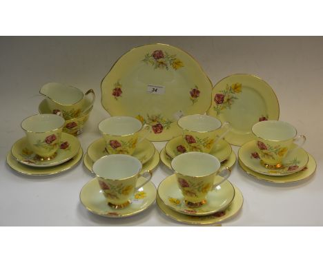 An Imperial China tea set, yellow ground, floral decoration, six cups and saucers, six side plates, a bread and butter plate,