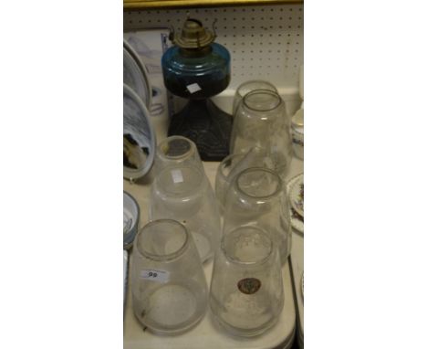 A Victorian cast iron oil lamp, turquoise reservoir, cast iron base, with seven clear glass shades